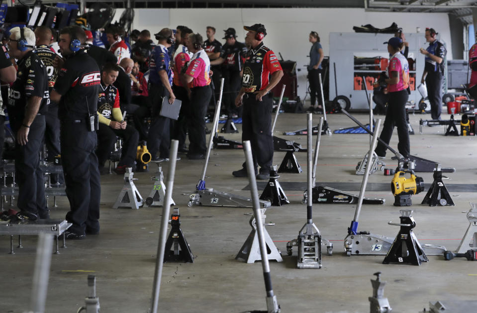 Teams monitor data and watch their racers on displays from their empty garages during a NASCAR Cup Series auto race practice at New Hampshire Motor Speedway in Loudon, N.H., Saturday, July 20, 2019. (AP Photo/Charles Krupa)