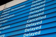 FILE PHOTO: The information board shows cancelled and delayed Amtrak trains at Penn Station during a winter nor'easter in New York