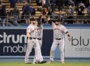 Apr 1, 2019; Los Angeles, CA, USA; San Francisco Giants outfielders Gerardo Parra (8), Steven Duggarand (6) and Michael Reed (52) celebrate after defeating the Los Angeles Dodgers at Dodger Stadium. Mandatory Credit: Kirby Lee-USA TODAY Sports