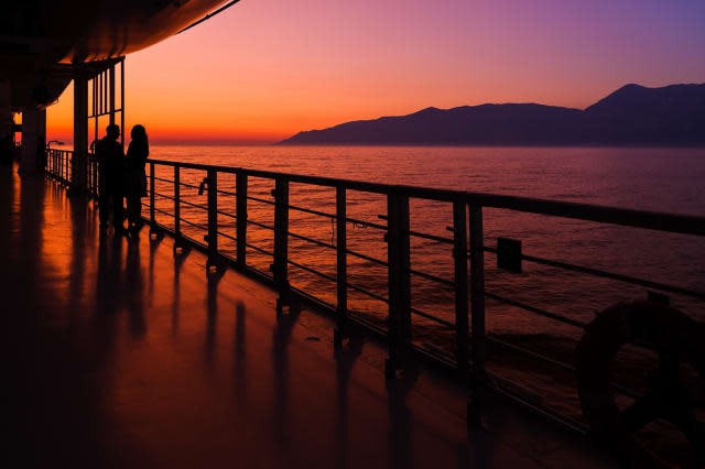 couple on a cruise ship at sunset