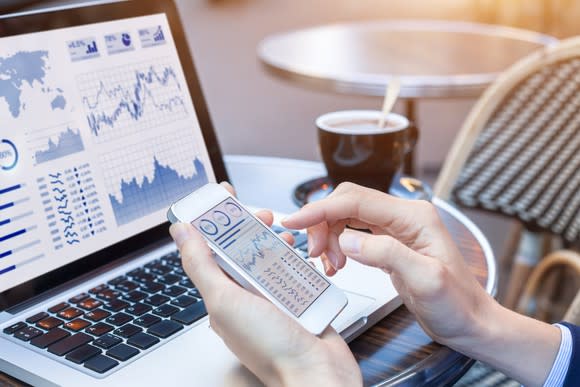 An investor checks stock holdings on a smartphone.