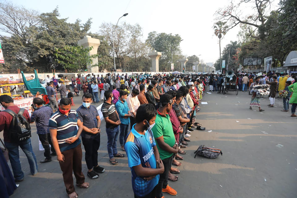 Protesters offer Friday prayers as they protest the death in prison of a writer who was arrested on charges of violating the sweeping digital security, in Dhaka, Bangladesh, Friday, Feb. 26, 2021. Mushtaq Ahmed, 53, was arrested in Dhaka in May last year for making comments on social media that criticized the Prime Minister Sheikh Hasina government's handling of the coronavirus pandemic. He had been denied bail at least six times. (AP Photo/Mahmud Hossain Opu)