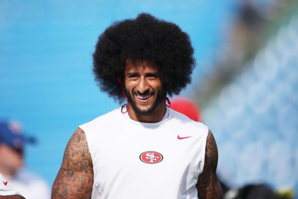 Colin Kaepernick - and his fabulous 'fro - warm up before San Francisco plays Buffalo (Getty Images)