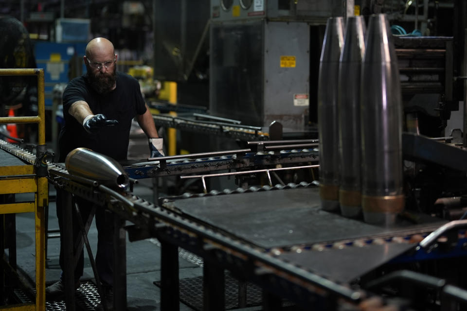 A steel worker moves a 155 mm M795 artillery projectile at the Scranton Army Ammunition Plant, Tuesday, Aug. 27, 2024, in Scranton, Pa. (AP Photo/Matt Slocum)