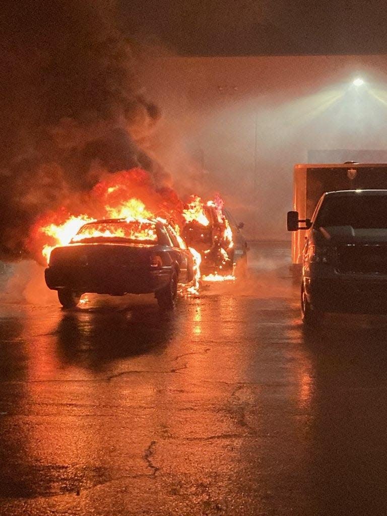 Pictured is two unmarked vehicles burning in the parking lot of the Portland Police Training Division.