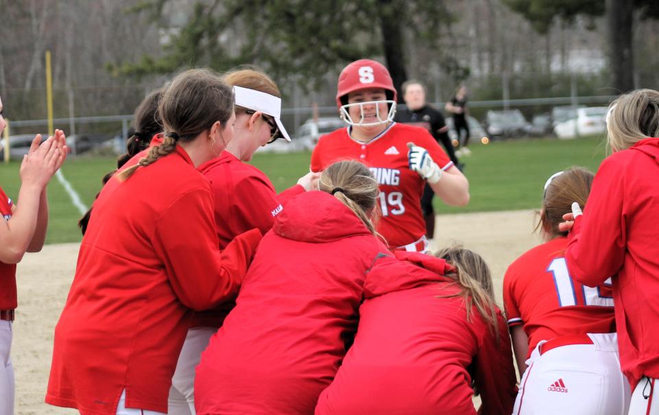 Spaulding's Bella Sherman has a welcoming committee at home plate after blasting a two-run homer in the sixth inning of Friday's game against Portsmouth in Rochester. Spaulding improved to 3-1 on the season with a 10-1 win.