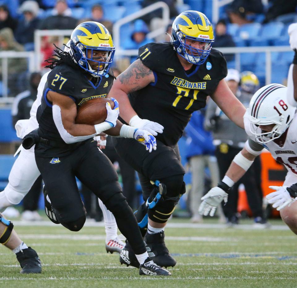 Delaware running back Jo'Nathan Silver runs the ball as offensive lineman Patrick Shupp moves along with him in the third quarter of the Blue Hens' 36-34 win against Lafayette in the opening round of the NCAA FCS playoffs Saturday, Nov. 25, 2023 at Delaware Stadium.