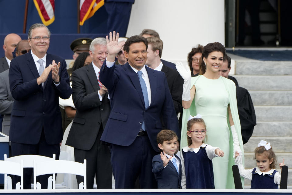 Florida Gov. Ron DeSantis, left, stands with his wife Casey, right, and their children Mason, Madison, and Mamie during an inauguration ceremony at the Old Capitol, Tuesday, Jan. 3, 2023, in Tallahassee, Fla. At left is former Florida Gov. Jeb Bush. (AP Photo/Lynne Sladky)