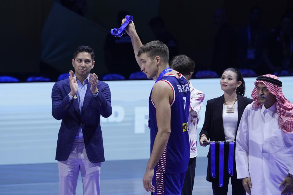 Serbia guard Bogdan Bogdanovic (7) holds a silver medal after losing to Germany in the championship game of the Basketball World Cup in Manila, Philippines, Sunday, Sept. 10, 2023. (AP Photo/Michael Conroy)