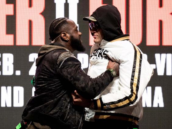 Wilder and Fury shove each other at the final press conference (EPA)