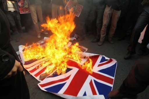 Iranian protesters burn the Union Jack outside the British embassy in Tehran on November 29. Iran's regime has started to distance itself from militant protesters who stormed Britain's embassy, after seemingly being caught off balance by the retaliatory closure of its mission in London