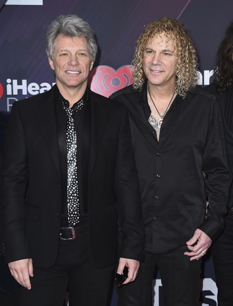 FILE - This March 11, 2018 file photo shows Jon Bon Jovi, left, and David Bryan, of Bon Jovi, at the iHeartRadio Music Awards in Inglewood, Calif. Bryan, the keyboardist for Bon Jovi is embarking on a busy 2020, with a new album and tour with one of America's favorite rock bands as well as opening his second Broadway musical, “Diana. (Photo by Jordan Strauss/Invision/AP, File)