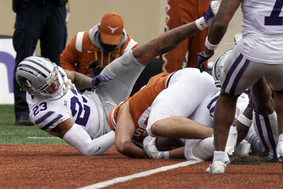 Texas tight end Cade Brewer, right, catches a touchdown pass as Kansas State defensive back Julius Brents (23) defends during the first half of an NCAA college football game in Austin, Texas, Friday, Nov. 26, 2021. (AP Photo/Chuck Burton)