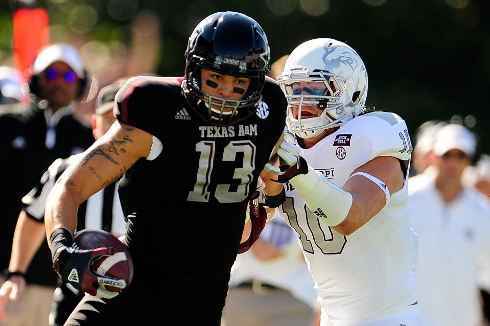 Mike Evans #13 of the Texas A&M Aggies avoids a tackle by Cameron Lawrence #10 of the Mississippi State Bulldogs at Wade Davis Stadium on November 3, 2012 in Starkville, Mississippi. (Photo by Stacy Revere/Getty Images)