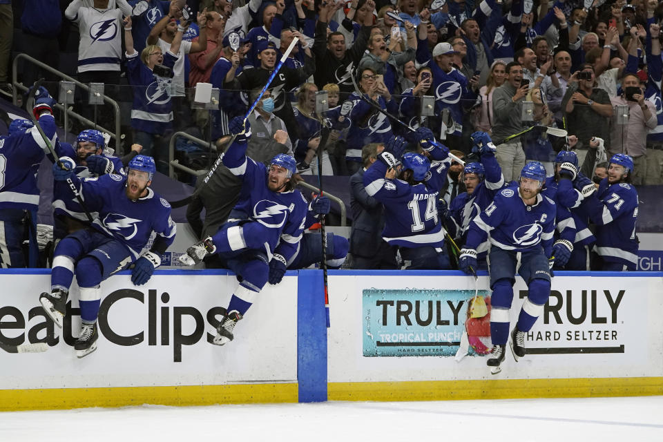 Tampa Bay Lightning players celebrate after defeating the New York Islanders in Game 7 of an NHL hockey Stanley Cup semifinal playoff series Friday, June 25, 2021, in Tampa, Fla. (AP Photo/Chris O'Meara)