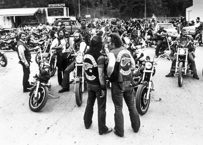 Image: Sonny Barger, right, and an unidentified member from the New York chapter stand in front of a group of Hell's Angels members on motorcycles. (Bettmann Archive / Getty Images file)