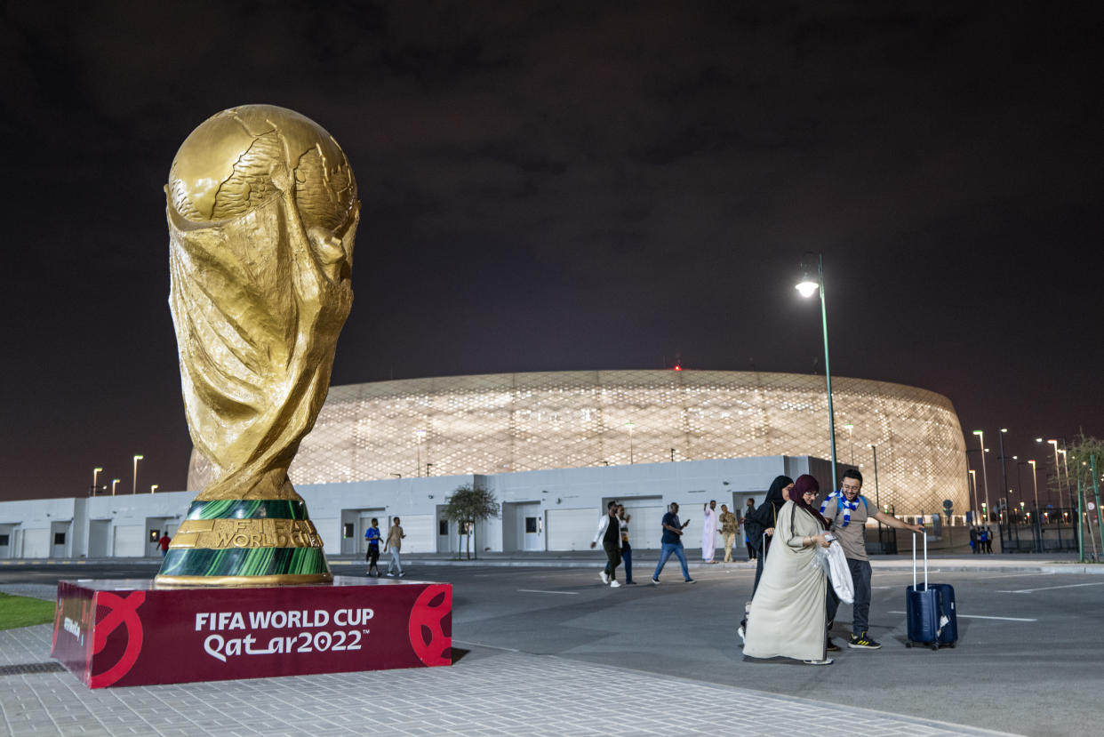 DOHA, QATAR - FEBRUARY 26: Fans of Al Hilal SFC leave the Al Thumama Stadium in Doha after the 0-7 victory walking past a giant commemorative sculpture of the FIFA World Cup Trophy in the AFC Champions League - Western Region - Semi Final Match between Al-Duhail v Al-Hilal SFC at Al Thumama Stadium on February 26, 2023 in Doha, Qatar. (Photo by Matthew Ashton - AMA/Getty Images)