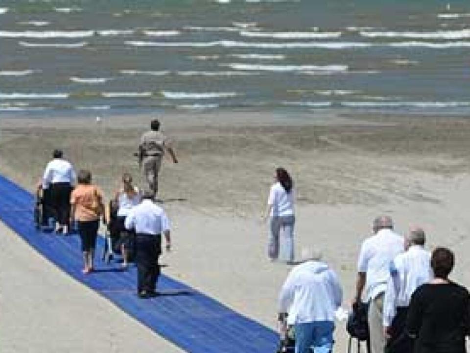 Mobi-mats allows wheelchair users to move across the sand to the water. Parlee Beach in New Brunswick will be unrolling its mat in the next couple of weeks. (Mobi-Mat - image credit)