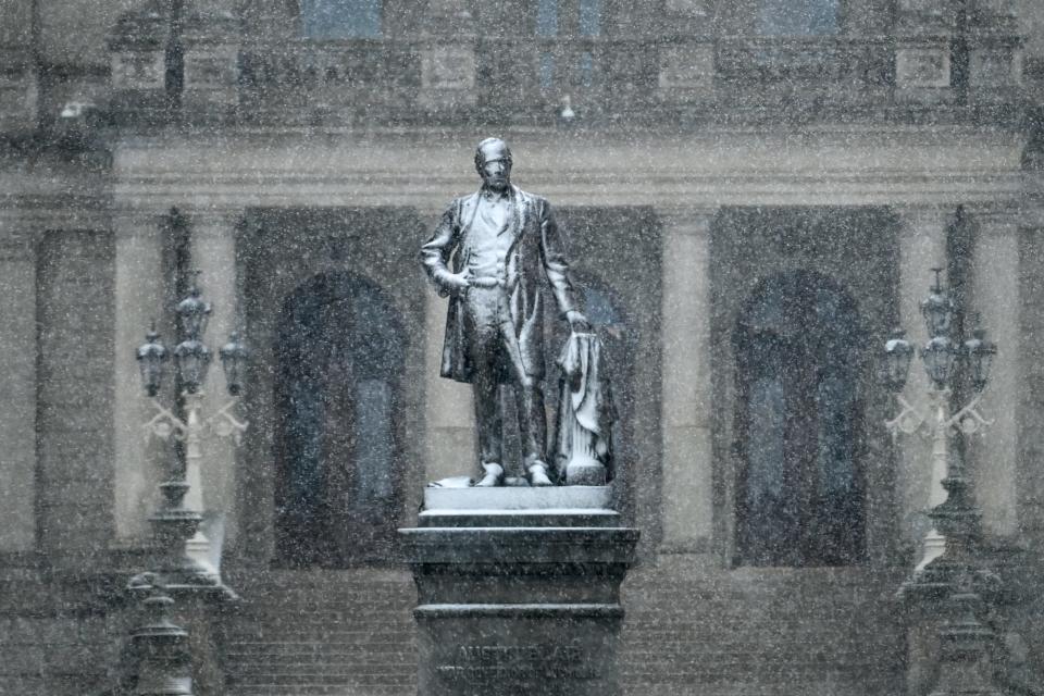 Snow covers the Governor Austin Blair Memorial on Friday, March 3, 2023, outside the Capitol in Lansing.