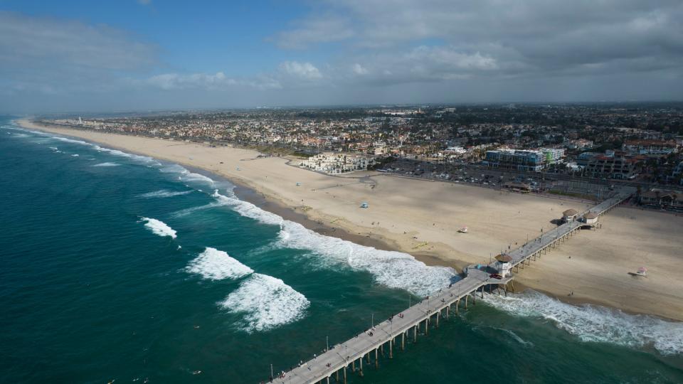 This aerial photo shows the pier and shoreline in Huntington Beach, California, on Oct. 11, 2021. The Hampton Beach Area Commission is undertaking a study to judge the feasibility and impact of building a pier off Hampton Beach, N.H.