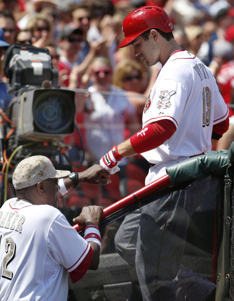 Reds Manager Dusty Baker (12) congratulates first baseman Joey Votto (19) after Votto hit a two-run homer to left field against Cleveland on May 27 2013.