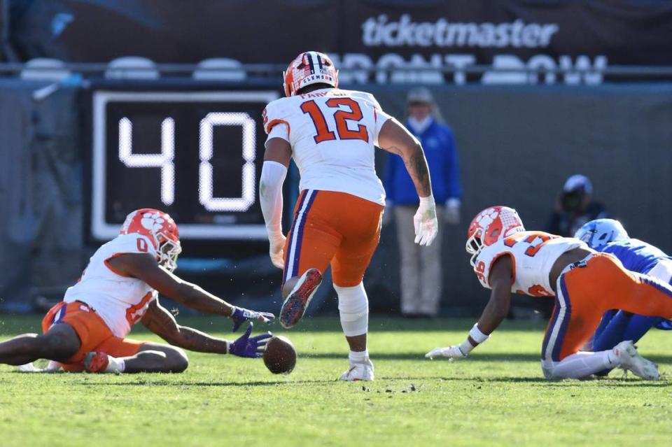 Clemson Tigers linebacker Barrett Carter (0) grabs a fumble from Kentucky Wildcats wide receiver Barion Brown (7) during fourth quarter action. The Kentucky Wildcats faced off against the Clemson Tigers Friday, December 29, 2023, in the TaxSlayer Gator Bowl in Jacksonville, Florida.