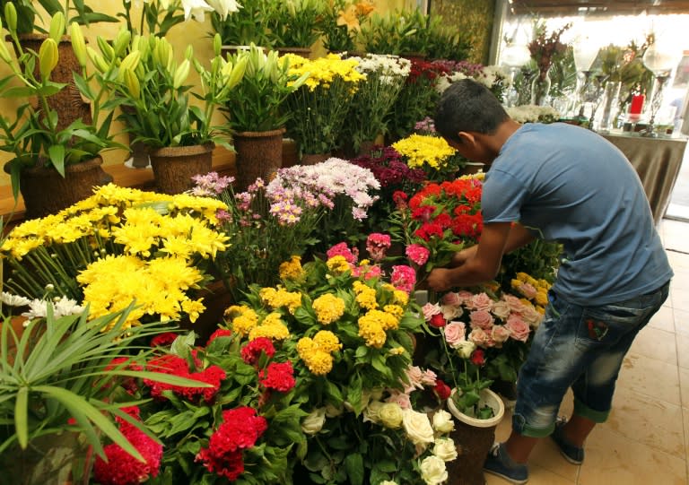 A 16-year-old Syrian Raed arranges flowers at a shop in the Lebanese capital, Beirut