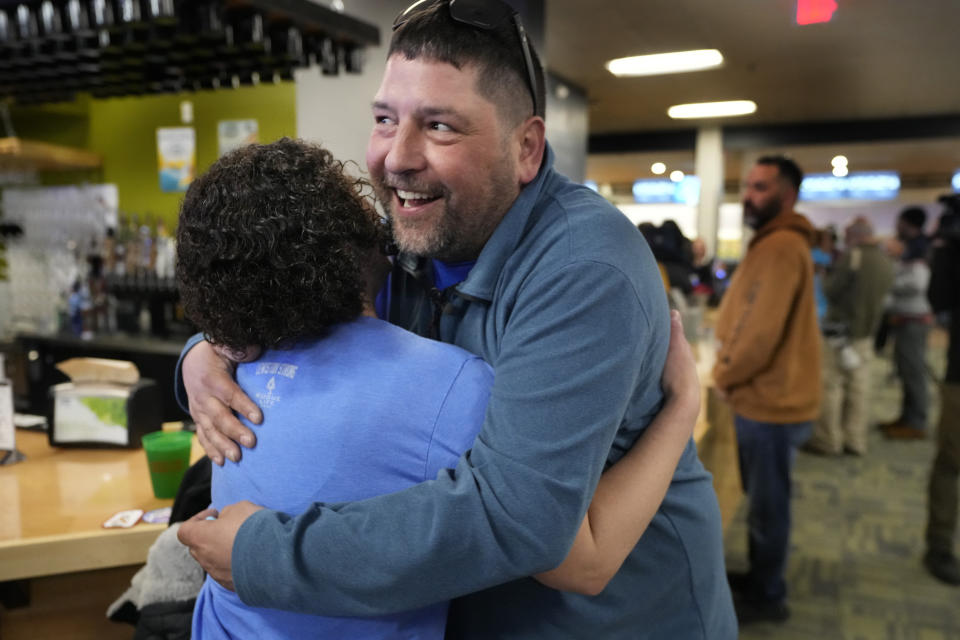 Justin Juray, owner of Just In Time Recreation, greets a customer during the reopening of the bowling alley six months after a deadly mass shooting, Friday, May 3, 2024, in Lewiston, Maine. (AP Photo/Robert F. Bukaty)