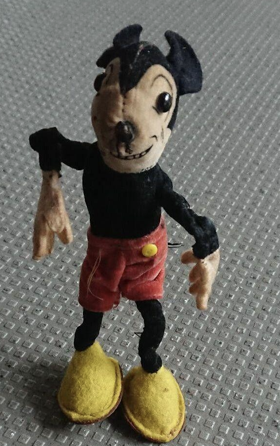 Mickey's face is distorted, the eyes too far apart, and his arms are dangling and look broken