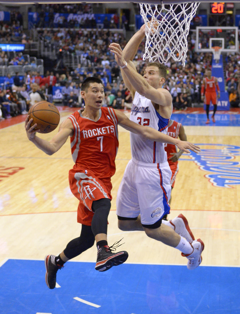 Houston Rockets guard Jeremy Lin, left, passes the ball as Los Angeles Clippers forward Blake Griffin defends during the first half of an NBA basketball game, Wednesday, Feb. 26, 2014, in Los Angeles. (AP Photo/Mark J. Terrill)