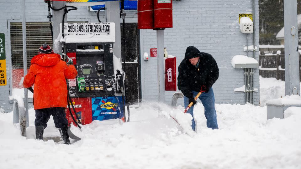 People shovel snow during one of New York's last major snowstorms on January 29, 2022. - Andrew Theodorakis/Getty Images