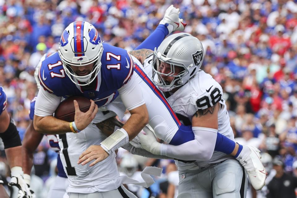 Las Vegas Raiders' Maxx Crosby (98) and Marcus Epps (1) tackle Buffalo Bills quarterback Josh Allen (17) during the first half of an NFL football game, Sunday, Sept. 17, 2023, in Orchard Park, N.Y. (AP Photo/Jeffrey T. Barnes)