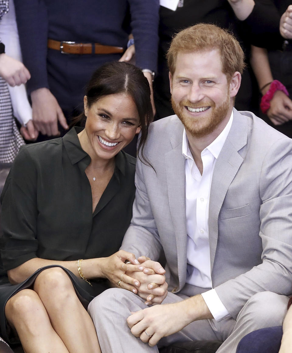 FILE - In this file photo dated Wednesday Oct. 3, 2018, Meghan, Duchess of Sussex and Britain's Prince Harry, make an official visit to the Joff Youth Centre in Peacehaven, Britain. Kensington Palace announced Monday Oct. 15, 2018, that Prince Harry and his wife the Duchess of Sussex are expecting a child in spring 2019. (Chris Jackson/pool via AP)