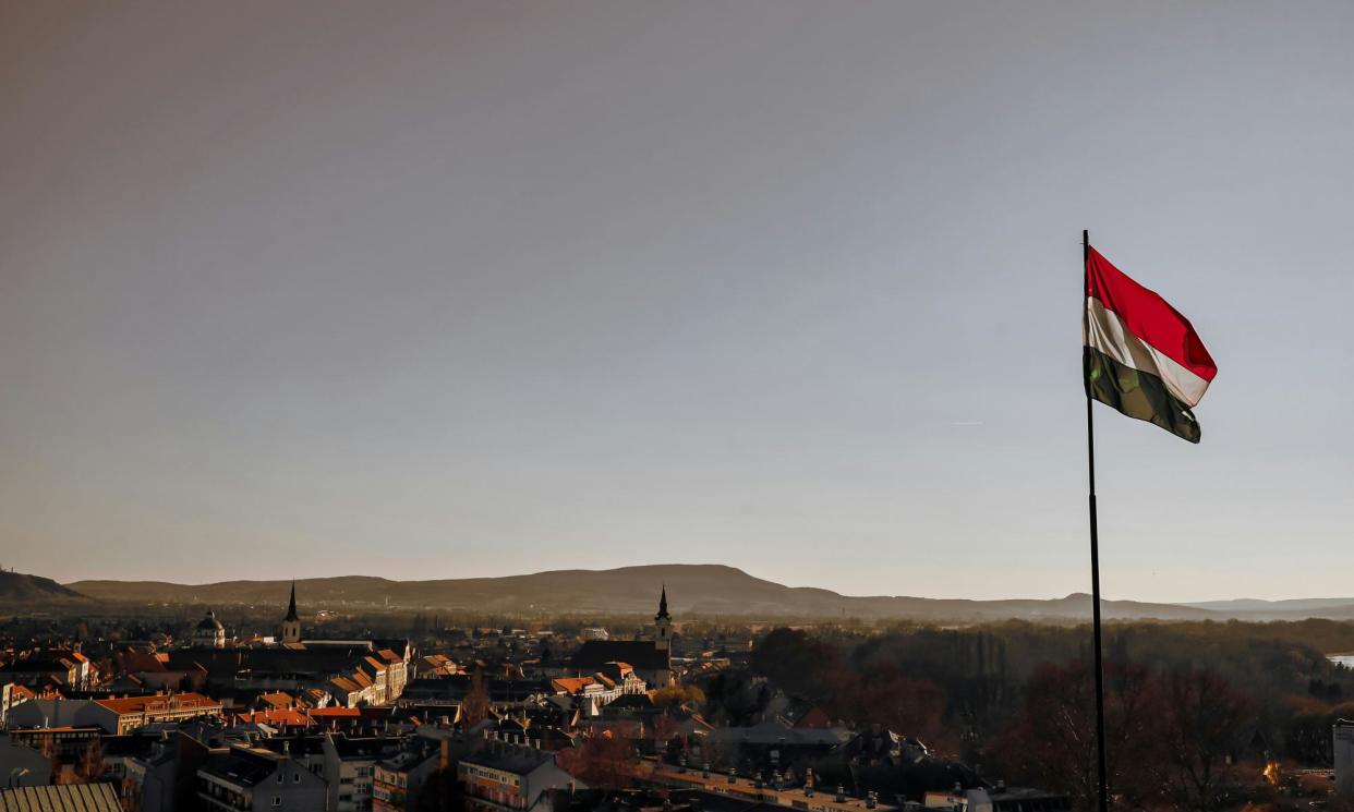 <span>A Hungarian flag is flying over the city of Esztergom, Hungary.</span><span>Photograph: Adam Papp for Unsplash/Guardian Community</span>