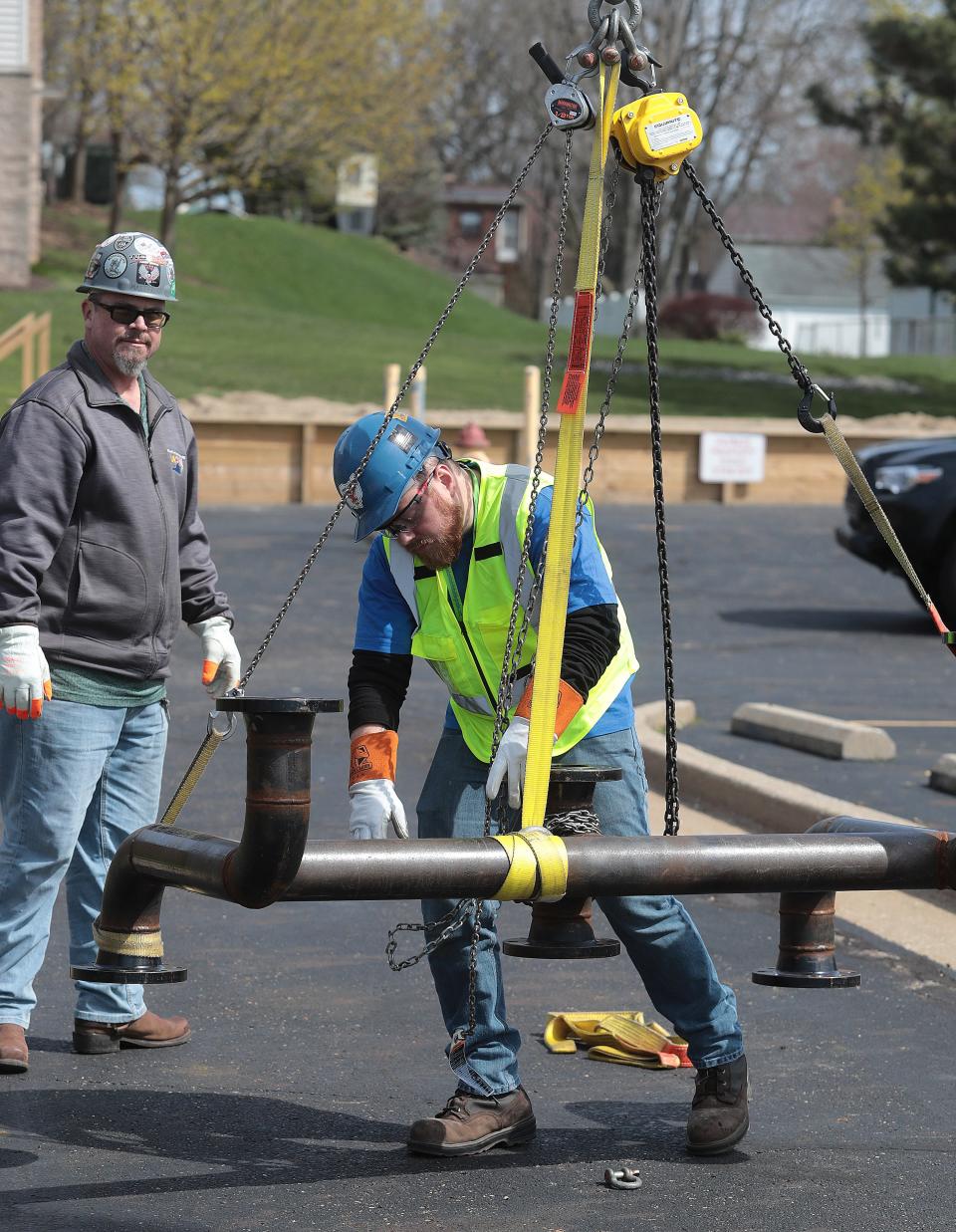 Competitor Vince Dodgson, right, of Plumbers & Pipefitters Local 396 out of Youngstown works on rigging infrastructure while watched by judge Steve Masterson out of Local 110 Norfolk, Virginia, during a statewide pipefitting competition last year in Canton.