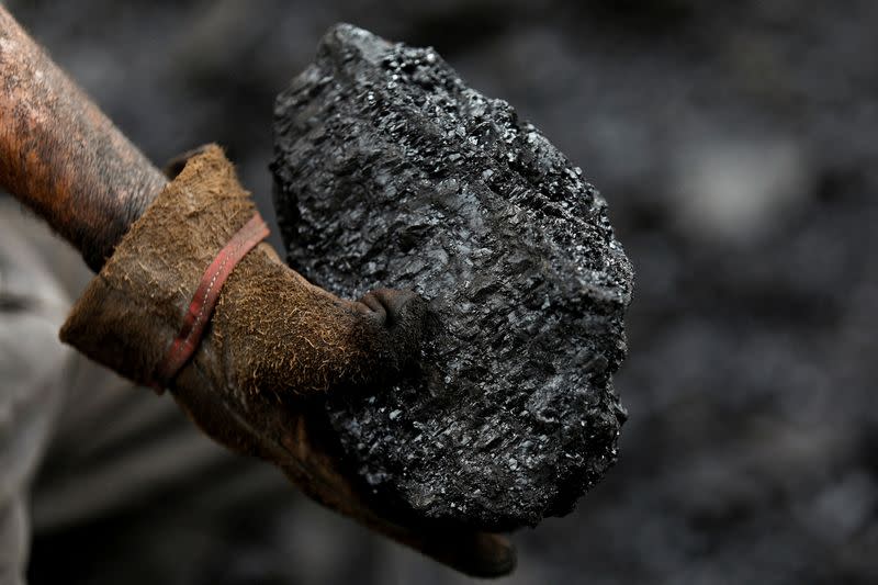 FILE PHOTO: A miner holds a piece of coal that was extracted from a coal mine, in Sabinas, Mexico