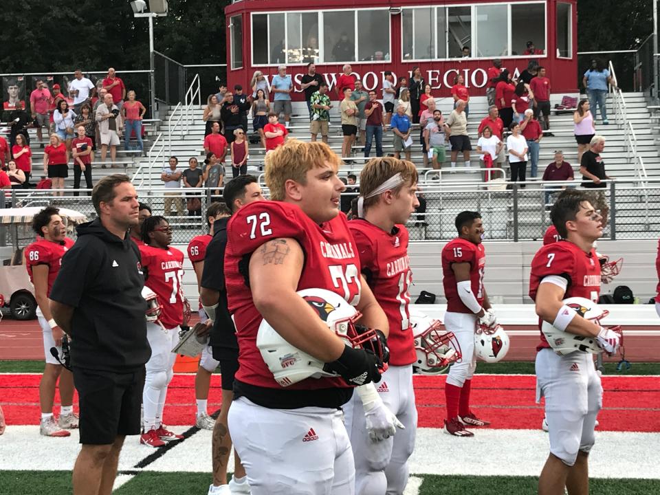 New coach Bobby Guy, left, and the Westwood football team lined up for the national anthem at the Jim Grasso Kickoff Classic on Friday, Aug. 25, 2023.