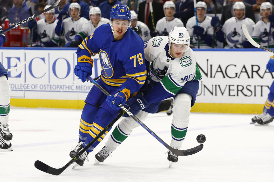 Buffalo Sabres defenseman Jacob Bryson (78) and Vancouver Canucks center Nils Aman (88) battle for the puck during the first period of an NHL hockey game, Tuesday, Nov. 15, 2022, in Buffalo, N.Y. (AP Photo/Jeffrey T. Barnes)