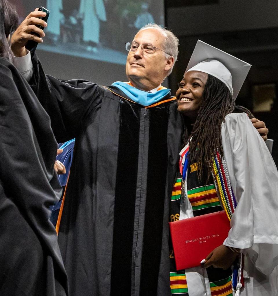 Ashley Adirika poses for a selfie with Miami Beach Mayor Dan Gelber at her Miami Beach High commencement ceremony at the University of Miami’s Watsco Center.