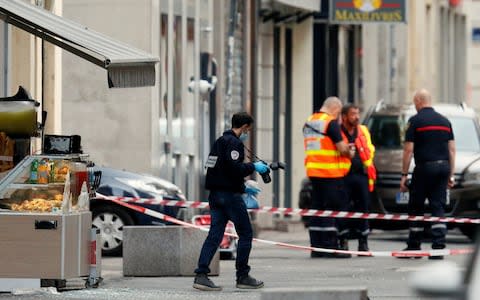 A police officer carrying evidence at the site of a suspected bomb attack in central Lyon - Credit: Emmanuel Foudrot/Reuters&nbsp;