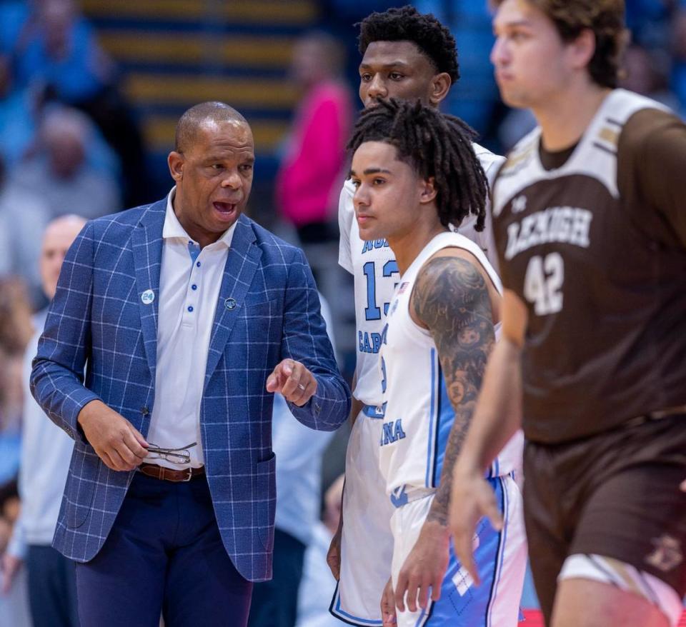 North Carolina coach Hubert Davis has a word with Elliot Cadeau (2) and Jalen Washington (13) before inserting them into the game in the first half against Lehigh on Sunday, November 12, 2023 at the Smith Center in Chapel Hill, N.C.