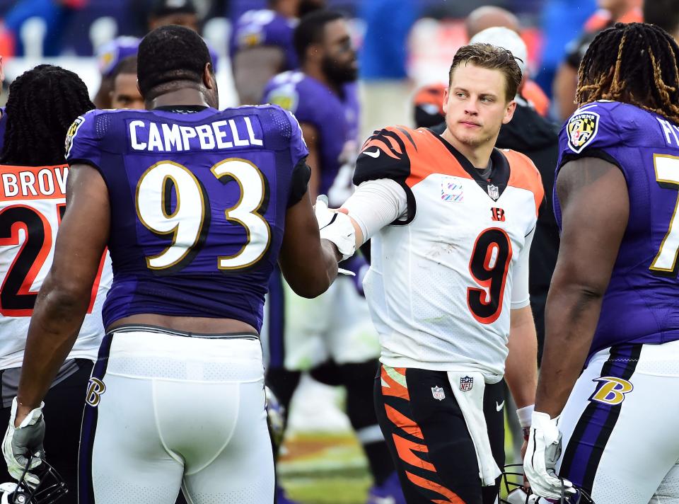 Oct 11, 2020; Baltimore, Maryland, USA; Cincinnati Bengals quarterback Joe Burrow (9) talks to Baltimore Ravens defensive end Calais Campbell (93) after the game at M&T Bank Stadium.