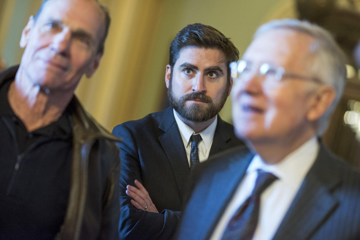 Adam Jentleson, center, appears with his boss Senate Minority Leader Harry Reid, D-Nev., right, and artist Michael Heizer, before an easement signing ceremony in the Capitol to help protect Nevada's Basin and Range National Monument that contains Heizer's modern art sculpture 