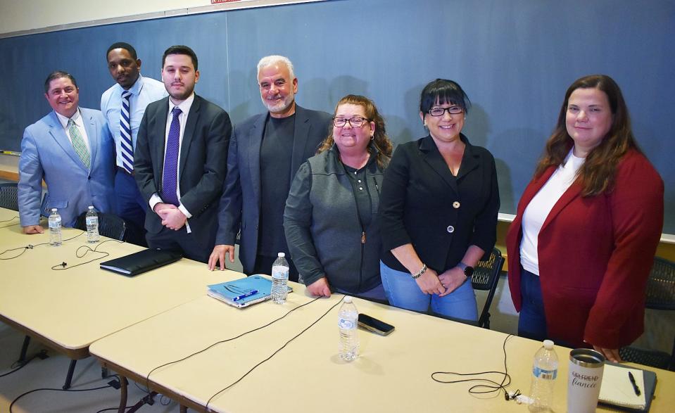 Fall River School Committee candidates Kevin Aguiar, Bobby Bailey, Colin Dias, Tom Khoury, Mimi Larrivee, Shelli Pereira and Sara Rodrigues pose for a group photo on Oct. 10, 2023.