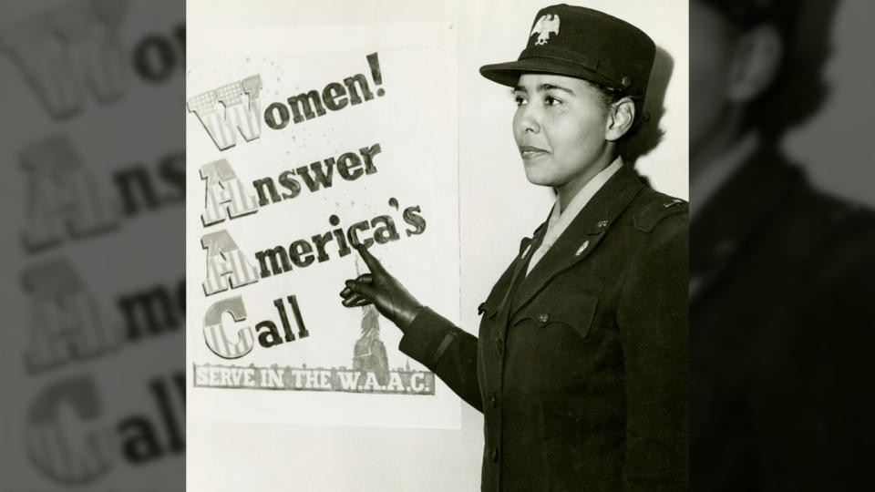 Charity Adams, standing in uniform, points to a poster that reads: Women! Answer America's Call, Serve in the W.A.A.C.