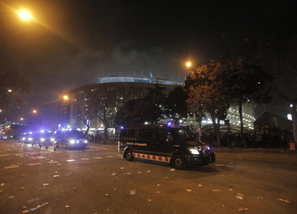 Police vehicles drive past the Camp Nou stadium at the end of a Spanish La Liga soccer match between Barcelona and Real Madrid in Barcelona, Spain, Wednesday, Dec. 18, 2019. Thousands of Catalan separatists protested around and inside Barcelona's Camp Nou Stadium during Wednesday's match against fierce rival Real Madrid. (AP Photo/Joan Mateu)