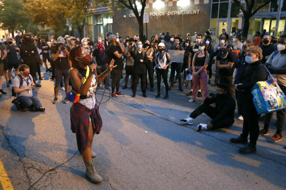 Ariel Atkins, a lead organizer for Black Lives Matter Chicago, leads a protest Monday, Aug. 10, 2020, outside the Chicago Police Department's District 1 station in Chicago. (AP Photo/Charles Rex Arbogast)