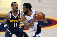 Orlando Magic guard Chasson Randle, right, looks to pass the ball as Denver Nuggets guard Monte Morris defends during the first half of an NBA basketball game Sunday, April 4, 2021, in Denver. (AP Photo/David Zalubowski)