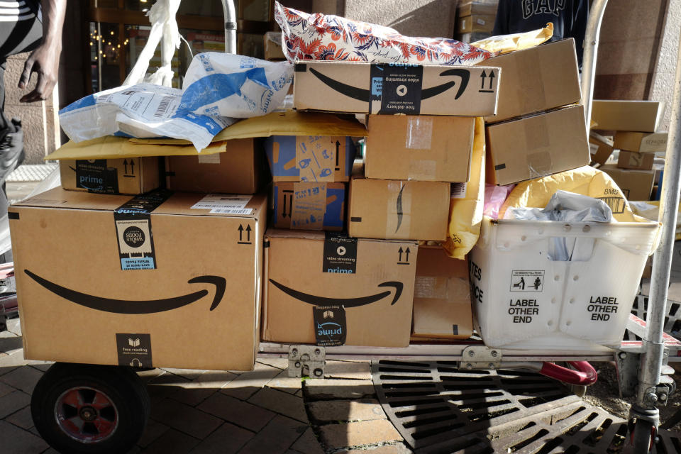 Amazon Prime boxes are loaded on a cart for delivery, Oct. 10, 2018 in New York. (AP Photo/Mark Lennihan)