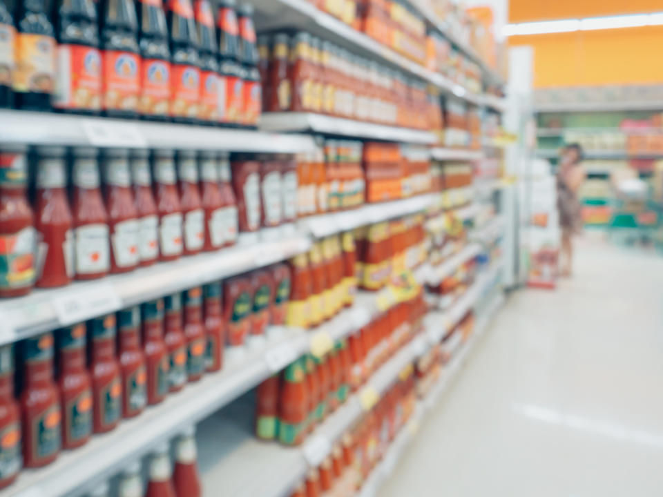 ketchup sauce seasoning bottles products in supermarket shelves blurred background